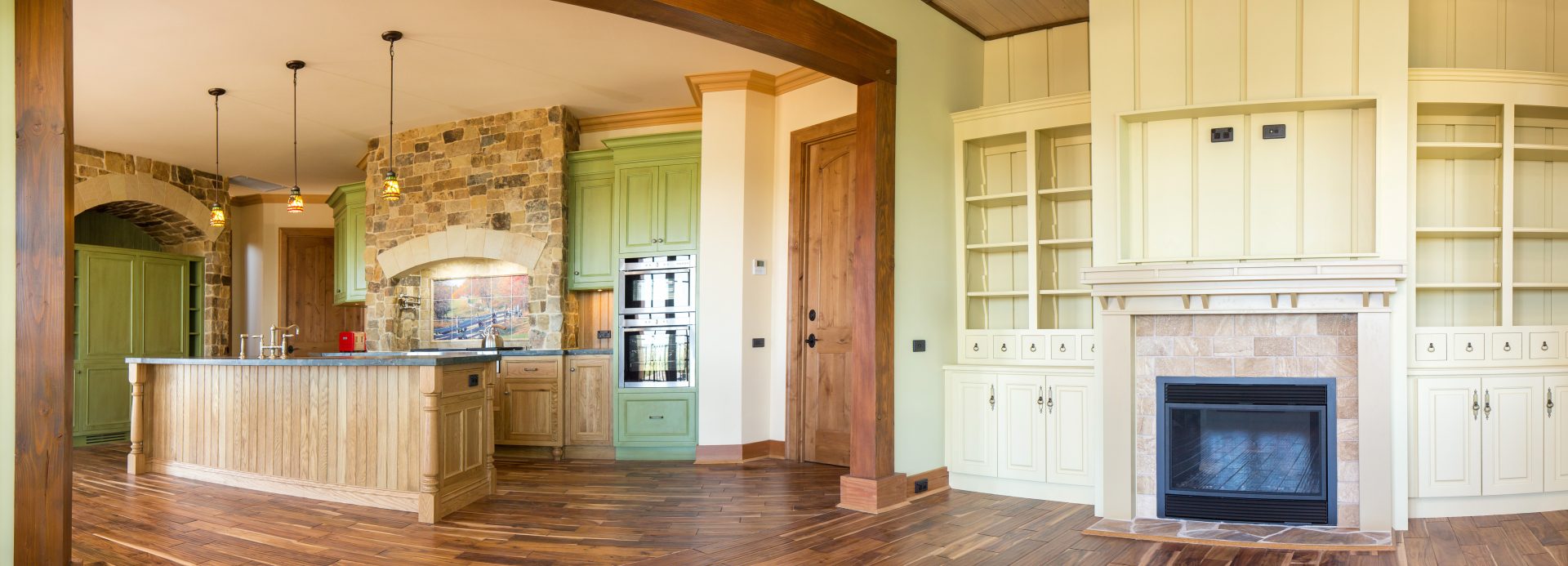 Award-winning American-style stone kitchen with custom timber joinery, arched stone surrounds and farmhouse detailing.